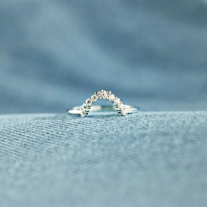 Macro shot of silver S925 sterling silver arched ring with pavé-set cubic zirconia stones