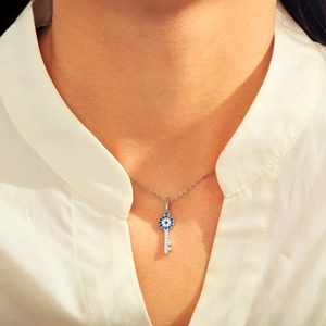Collier pendentif clé mauvais œil en argent S925 avec zircons porté par un mannequin
