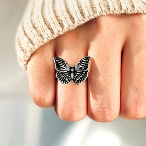 Vintage s925 silver butterfly ring with black textured wings on female finger