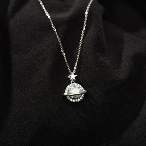Macro shot of S925 sterling silver planet pendant necklace with zircon saturn ring