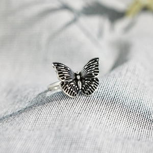 Macro shot of vintage S925 silver butterfly ring with intricate black oxidation details