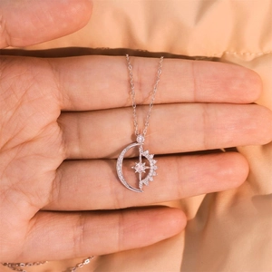 S925 sterling silver moon and star necklace with sparkling cubic zirconia on palm