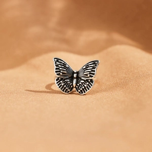 Macro shot of vintage S925 sterling silver butterfly ring with oxidized textured wings