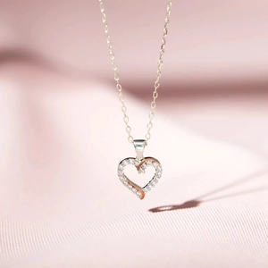 Close-up of S925 silver heart necklace with zircon stones and rose gold details