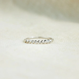 Close-up of a twisted s925 silver ring with pave set sparkling cubic zirconia stones
