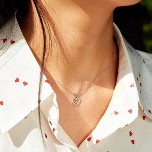 S925 sterling silver heart necklace with zircon pave on a model in sunlight