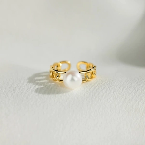 Minimalist S925 silver pearl chain ring with adjustable gold-tone band on white fabric