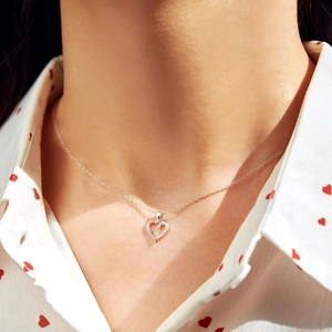 S925 sterling silver heart necklace with pavé cubic zirconia worn by a model