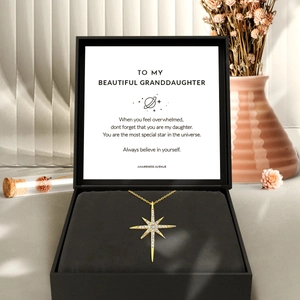 Gold North Star necklace with cubic zirconia pendant in a gift box with a card