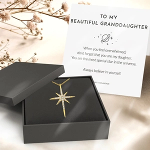 Gold North Star necklace with cubic zirconia on gift card in a premium jewelry box