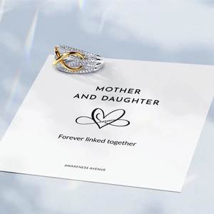 Detailed view of bicolor S925 infinity ring with zircons and gift card for mother daughter