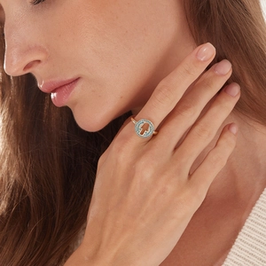 Gold Hamsa Hand ring for women with turquoise stone inlay on a model's finger