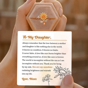 Close-up of sunflower spinner ring with card and hexagon velvet jewelry box