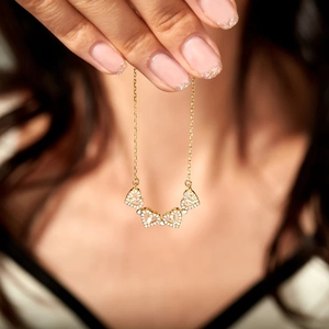 Close-up of gold-plated S925 sterling silver four-leaf clover necklace with cubic zirconia