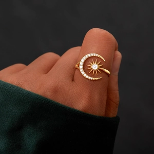 Minimalist gold S925 moon and star ring with sparkling zircons shown on a finger
