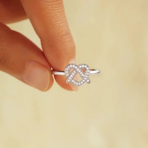 S925 sterling silver pretzel heart ring with sparkling cubic zirconia on a finger