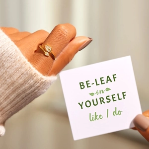 Elegant gold leaf ring with sparkling cubic zirconia on a minimalist adjustable band