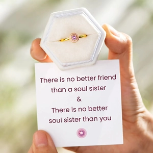 Pink round crystal ring in gold finish with enamel detail and a velvet jewelry box
