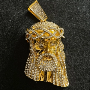 Detailed macro view of the gold plated hip hop Jesus pendant encrusted with clear crystals