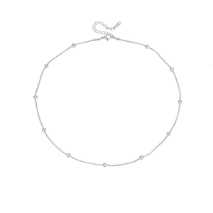 Detailed shot of silver snake chain necklace with polished beads and S.STEEL engraved tag