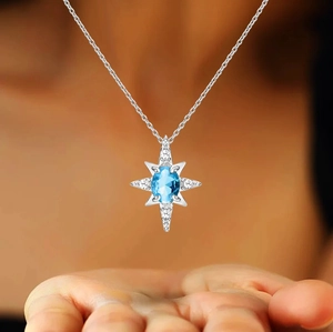 Macro view of s925 silver star necklace with blue topaz stone and zircon inlay