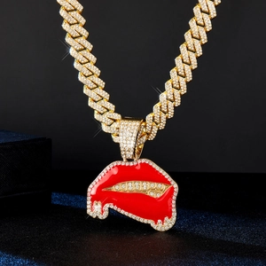 Détail du pendentif lèvres rouges avec strass sur une chaîne à maillons cubains dorés