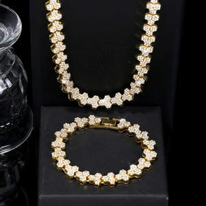 Detalle del conjunto de collar y pulsera de panal dorado con incrustaciones de diamantes