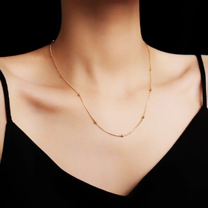 Elegant 18K gold plated titanium steel satellite chain necklace worn on a model