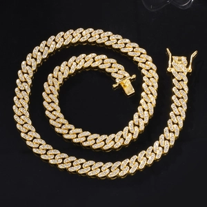 Détail macro de la chaîne cubaine de 9mm dorée avec strass pavés et fermoir sécurisé