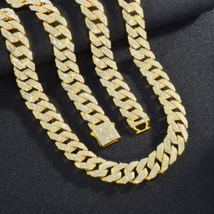 Close-up of a 14mm gold Cuban link chain with three rows of pavé-set rhinestones and clasp