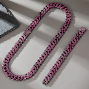 Macro detail of 14mm gunmetal cuban chain necklace set with pavé pink rhinestones