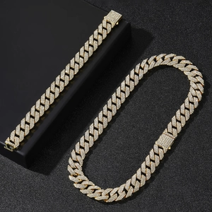 Detailed macro view of 14mm gold-plated iced out Cuban link chain necklace and bracelet