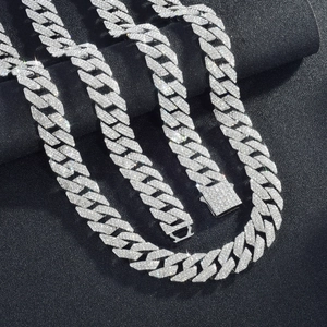 Macro detail of silver iced out cuban link chain with sparkling stones and box clasp