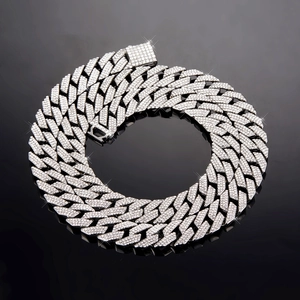 Macro view of 14mm silver Cuban chain featuring triple-row pave crystals and fold-over clasp