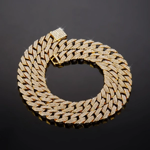 Macro detail of 14mm gold-plated Cuban link chain with three-row full rhinestone pave