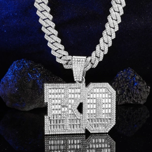 Macro shot of silver iced out ED letter pendant with micro-pave zircons on Cuban chain