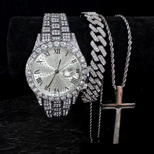 Macro detail of iced-out silver watch with Roman numerals and matching Cuban chain set