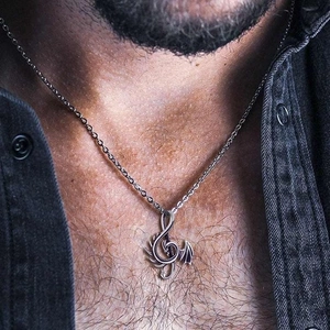 Men's S925 sterling silver dragon wing treble clef pendant necklace on black denim shirt