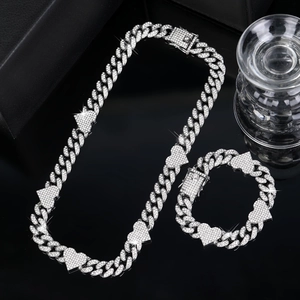 Iced out silver Cuban link chain necklace and bracelet set with heart diamond accents