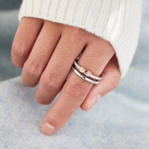 Close-up of s925 silver double layered ring with rose gold infinity sign and pavé stones