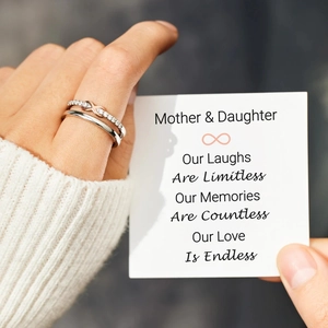 Close-up of S925 silver infinity rings with pavé cubic zirconia for mother and daughter