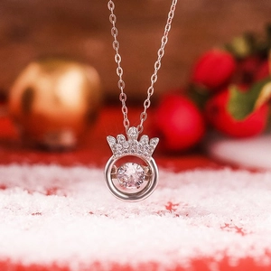 Macro detail of S925 sterling silver crown necklace with dancing stone in festive winter setting