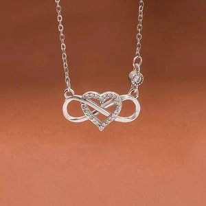 Macro detail of S925 silver infinity heart necklace with sparkling cubic zirconia