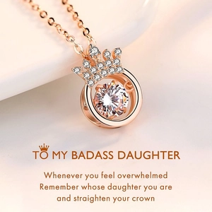 Macro view of rose gold crown heart necklace with shimmering zircon and inspiring text