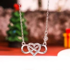 S925 sterling silver heart and infinity necklace with zircon stones on festive background
