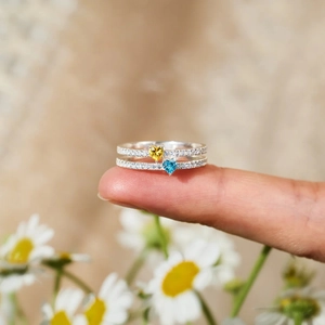 Elegant s925 silver double heart ring with blue and yellow zircon on a finger
