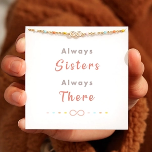 Gold infinity bracelet with colorful beads on an 'Always Sisters' sentiment card