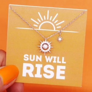 Macro detail of S925 sterling silver sun and star pendant necklace with sparkling stones