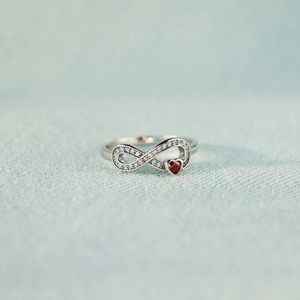 S925 sterling silver infinity ring with sparkling red heart stone and pavé setting