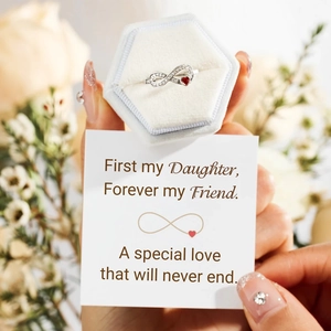 Infinity silver ring with red heart gemstone and diamonds in a white velvet gift box